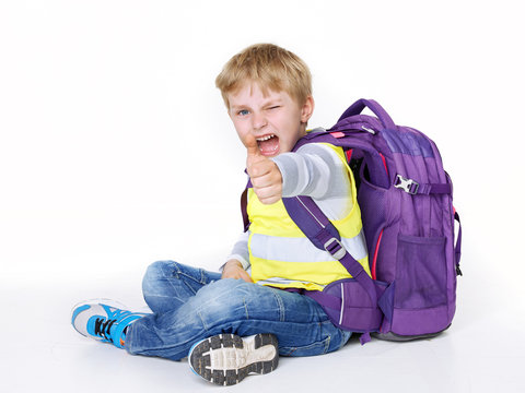 Boy with reflective vest shows thumb up