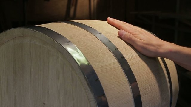 Hand irons oak wine barrels in the workshop.