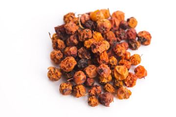 Dried rowan berries on a white background