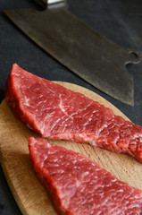 Raw beef steak with vintage cleaver