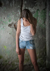 Sad woman sitting alone in a empty room