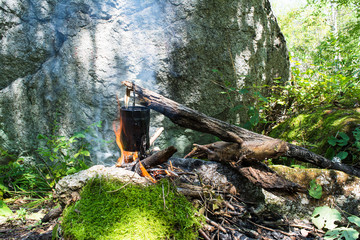 Cooking pot on the campfire during hiking