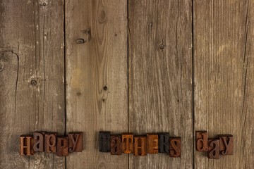 Happy Fathers Day wood letters on a rustic wooden background