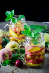 Jar delicious refreshing drink of peach fruits and plum  with mi