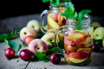 Jar delicious refreshing drink of peach fruits and plum  with mi