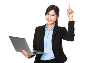 Young businesswoman use of the laptop and finger point up