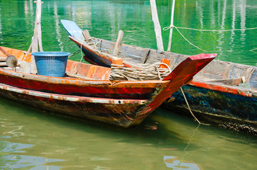 Wood Boats of Fisherman Floating On Green Clear Water.