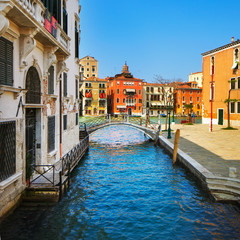 Fototapeta na wymiar Venice cityscape, bridge, tree and buildings on water grand cana