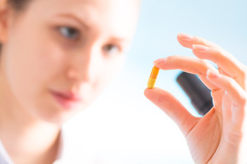 Doctor woman hold medicine capsule, pill in hand
