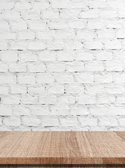Empty wooden table over white bick wall background