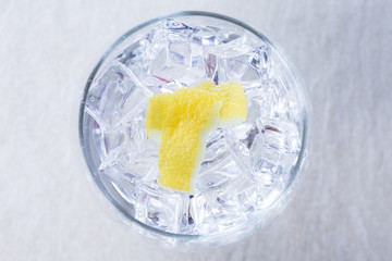 lemon peels on a gin tonic glass.