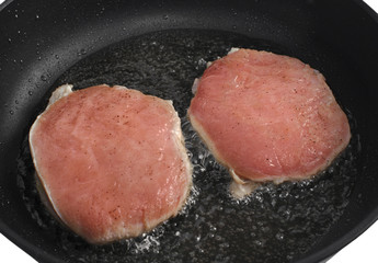 Steaks are fried in a skillet