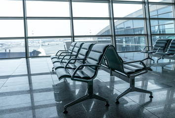 airport waiting area , seats and outside the window scene