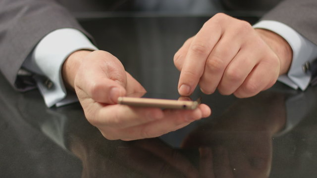 Top manager, boss typing text on smartphone, sending message