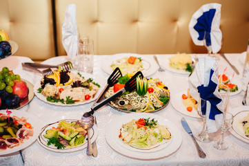 catering table set service with silverware and glass stemware at
