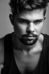 Obraz premium Black and white portrait of a young man in a black t-shirt