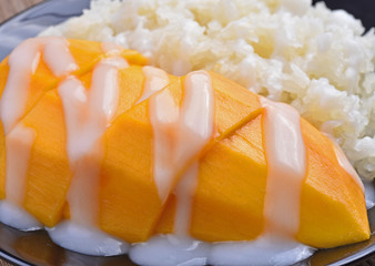 Mango sticky rice topped with coconut milk