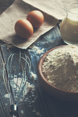 Flour and eggs on a wooden table