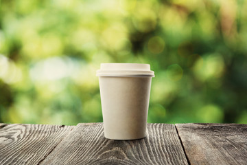 paper cup of coffee on natural background