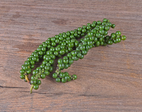  Freshly ground pepper  sheeds  on a wooden background