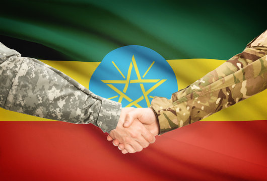 Men in uniform shaking hands with flag on background - Ethiopia