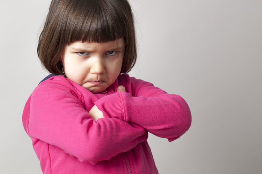 unhappy boyish 4-year old girl expressing disagreement