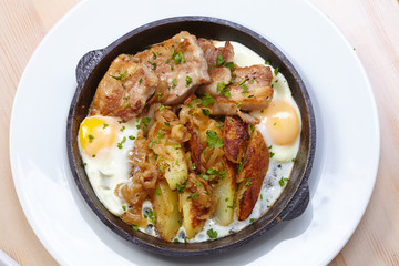 fried meat with potatoes and egg