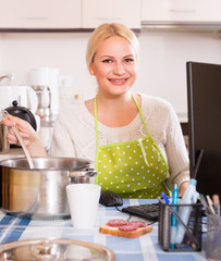 freelancer with dishware working on PC