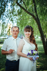 wedding couple kissing in green summer park. bride and groom