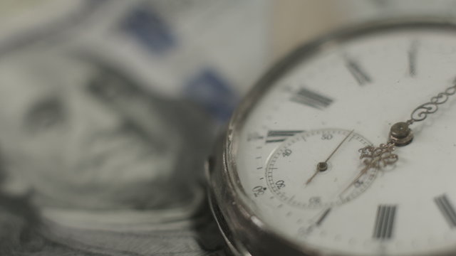 American dollars, money, time running. Benjamin Franklin closeup