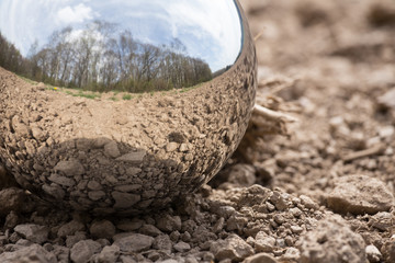 reflecting sphere on brown earth