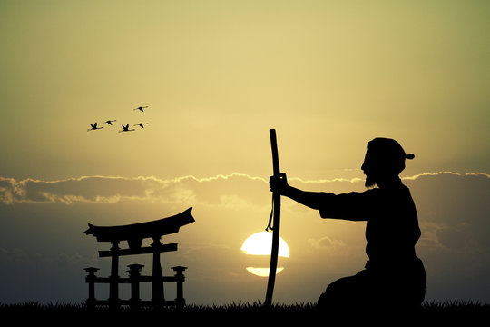 Japanese man with sword at sunset