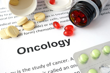 Paper with Oncology  and pills. Medical concept.