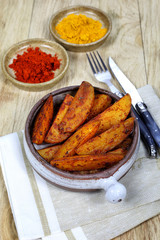 Roast potatoes with spices in ceramic dish