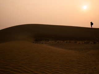 Fototapeta na wymiar Silhouette photographer at Thar Desert in sunset time, Jaisalmer