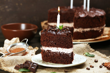 Delicious chocolate cake on table on brown background