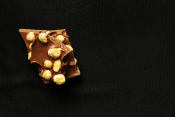 Chocolate with nuts on black background