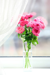Bouquet of beautiful fresh roses on curtains background