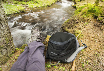 Hiker Resting in the Forest next to River