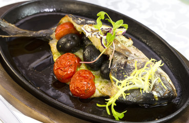 Fried fish dorado with vegetables and lemon