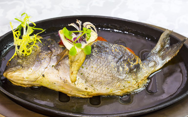 Fried fish dorado with vegetables and lemon