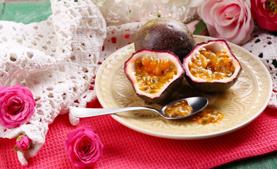 Passion fruit on plate on color wooden background
