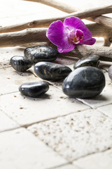 Fototapeta na wymiar zen pebbles with orchid for beauty atmosphere