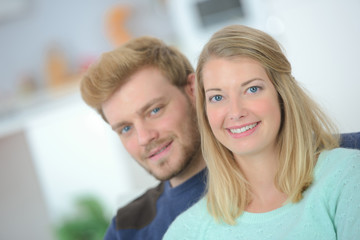 Affectionate couple sat on a sofa