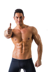 Fototapeta premium Muscular man shirtless doing thumb up sign for OK, smiling