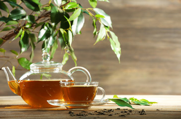 Cup of green tea on table on wooden background