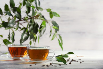 Cups of green tea on table on wooden background