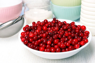 Cranberries in bowl on kitchen table close up