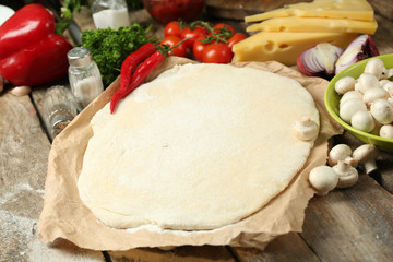 Food ingredients for pizza on table close up