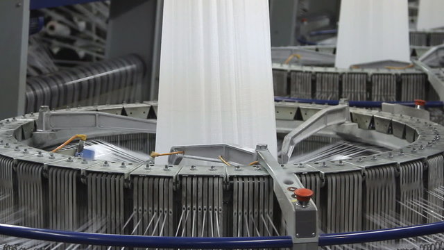 Textile industry - yarn spools on spinning machine in a factory